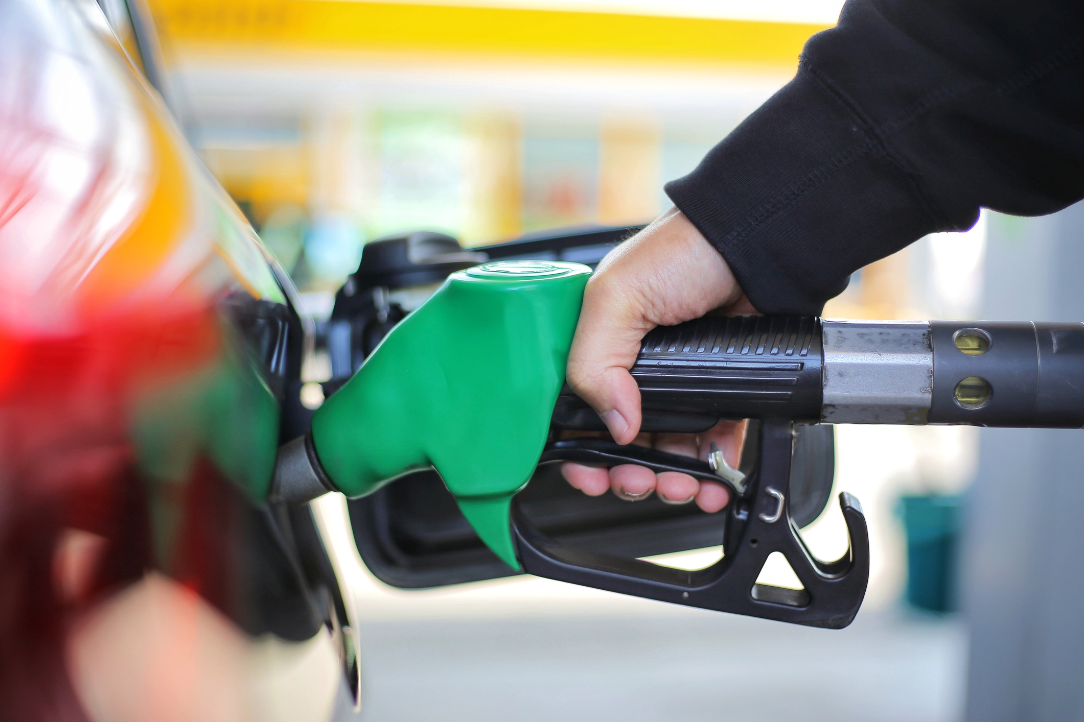 Petrol nozzle filling car - dreamstime_m_148961913